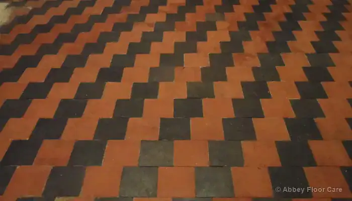 Traditional red quarry tile floor in a UK period property showing natural darkening and clay variation